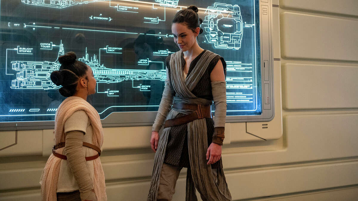 Rey speaks with a young passenger at Walt Disney World's Star Wars: Galactic Starcruiser in Lake Buena Vista, Fla.