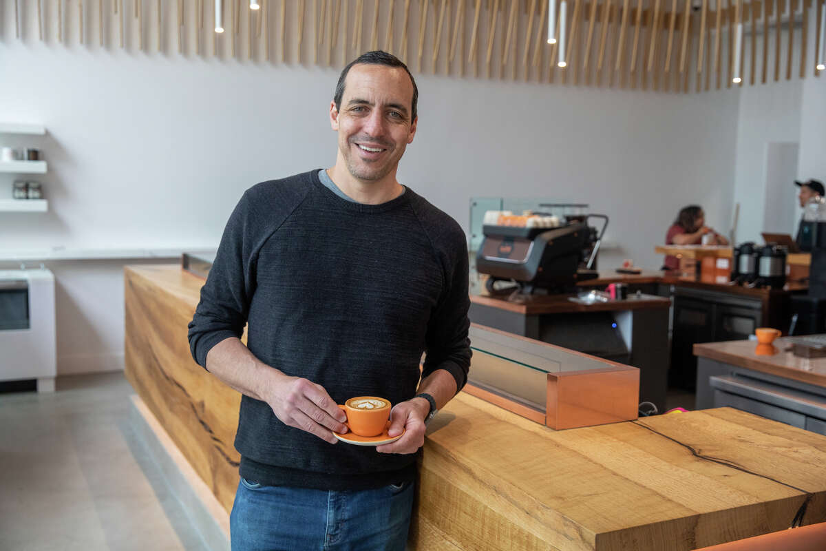 Owner Luigi Di Ruocco with an espresso drink in front of the traditional Italian standing coffee bar in the new Caffè by Mr. Espresso on Broadway in downtown Oakland, Calif., on May 18, 2023.