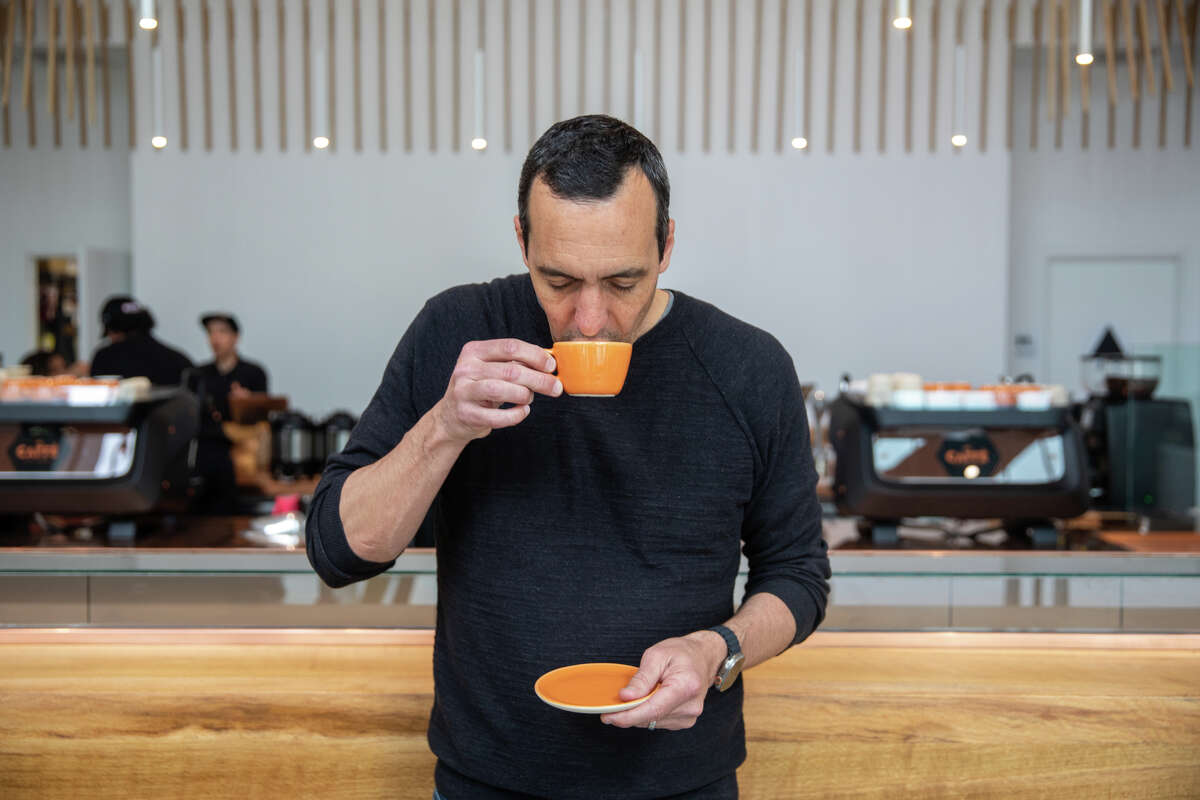 Owner Luigi Di Ruocco with an espresso drink in front of the traditional Italian standing coffee bar in the new Caffè by Mr. Espresso on Broadway in downtown Oakland, Calif., on May 18, 2023.