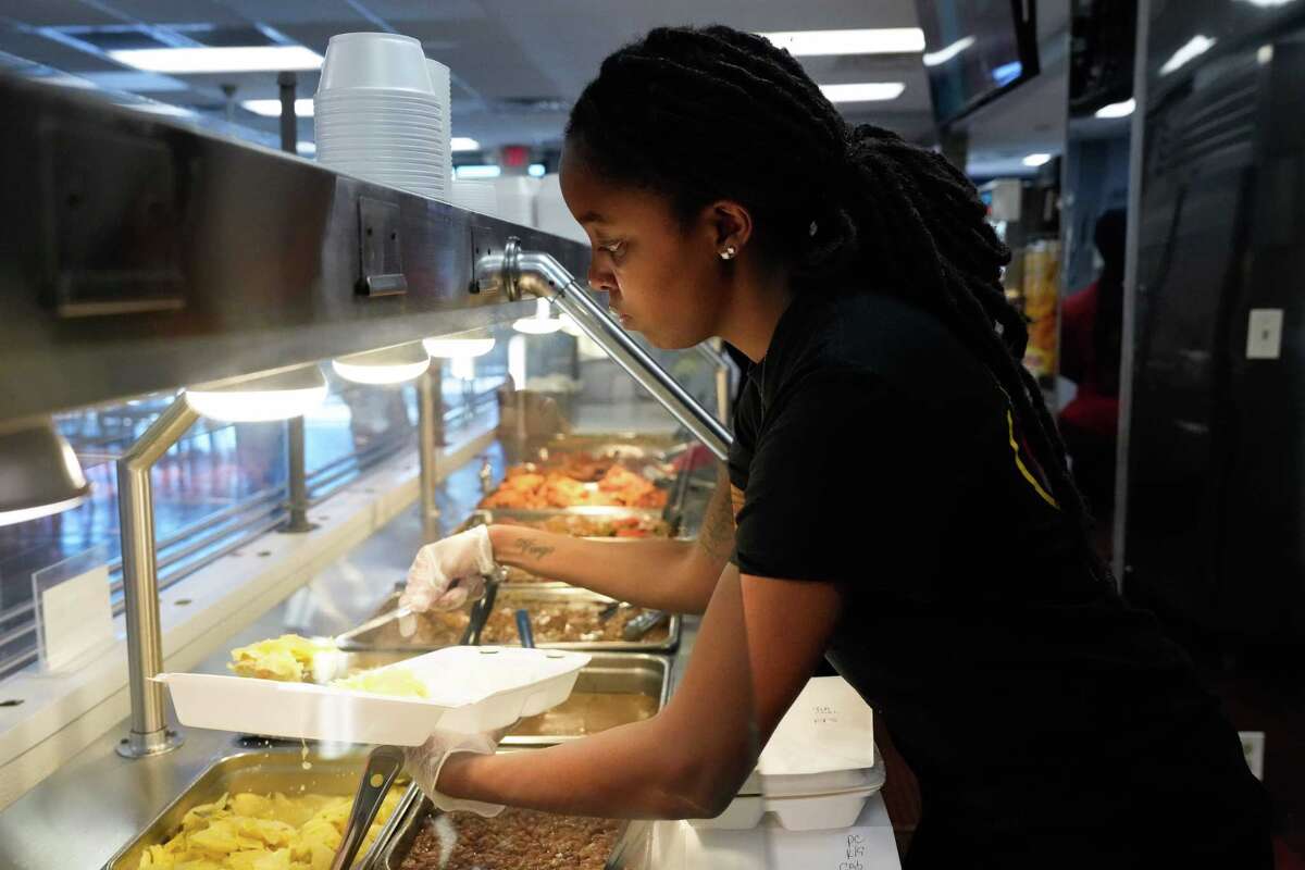 This Is It Soul Food staff Camryn Wilson fills an order during lunch hour Friday, May 19, 2023, at Third Ward in Houston. The famous soul food restaurant is opening a second location in Humble.
