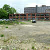 A lot adjacent to Platform SoNo Station and Shirt Factory Lofts is vacant in Norwalk, Conn. Monday, May 16, 2022. Connecticut Gov. Ned Lamont visited recently to tour the space and speak about the vacant property adjacent that will receive $6 million to add 200 units of mixed-income housing, 10,000 square feet of commercial space, a public plaza, and 60 off-street parking spaces.