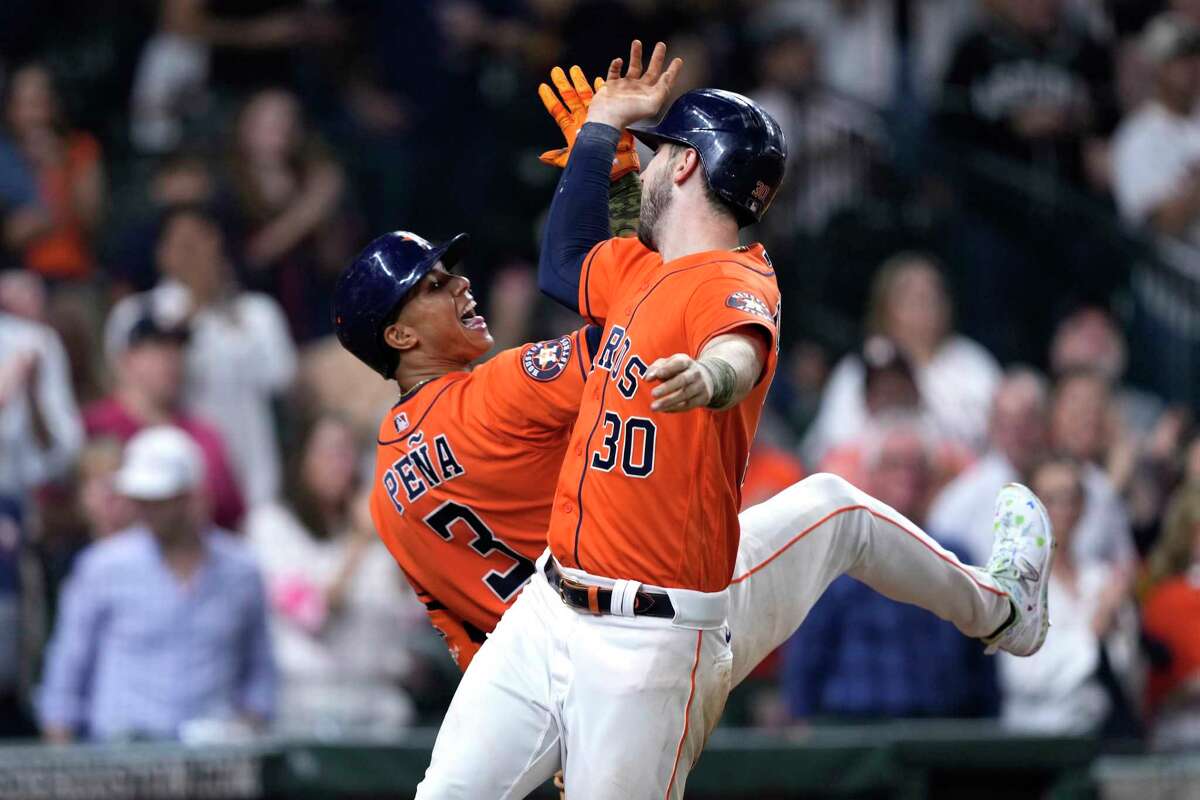 Houston Astros' Kyle Tucker (30) celebrates with Jeremy Pena (3) after hitting a two-run home run against the Oakland Athletics during the sixth inning of a baseball game Friday, May 19, 2023, in Houston.