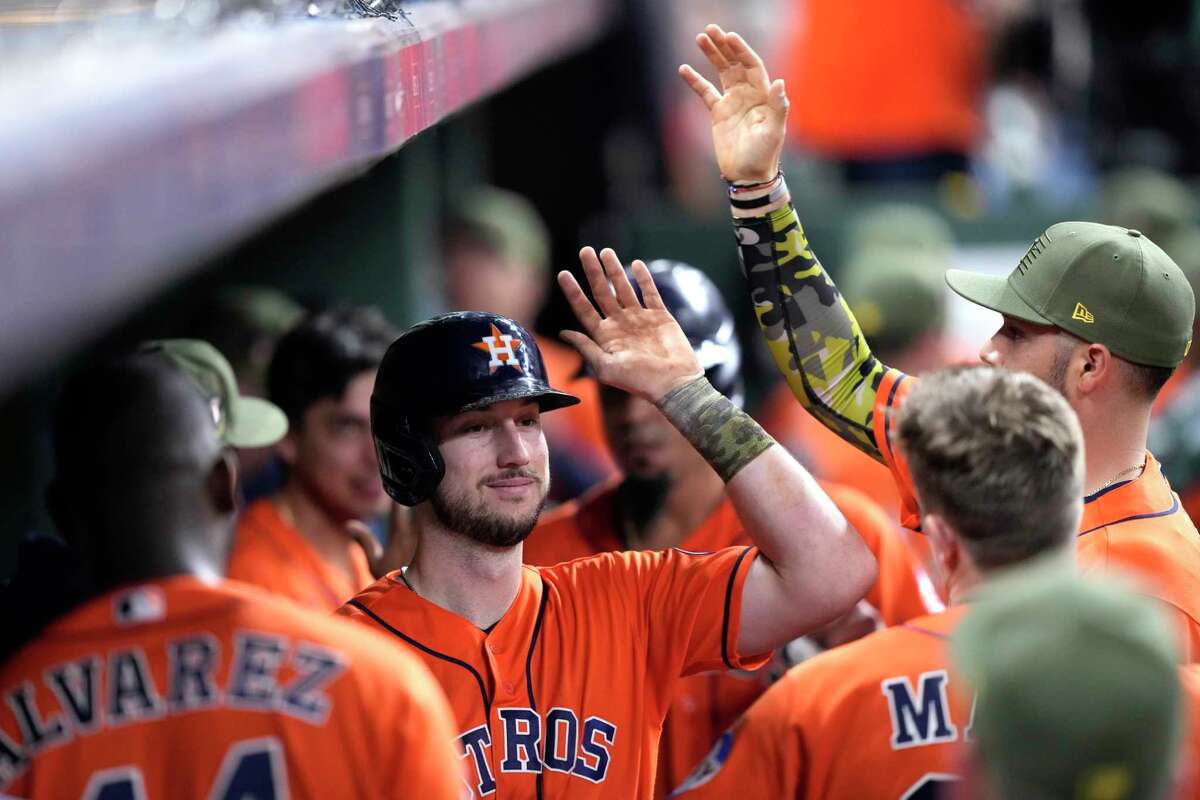 Houston Astros' Kyle Tucker celebrates in the dugout after hitting a two-run home run against the Oakland Athletics during the sixth inning of a baseball game Friday, May 19, 2023, in Houston.