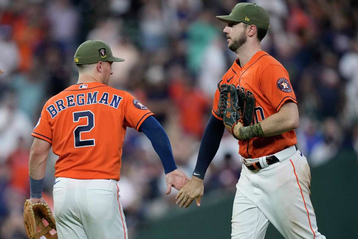Houston Astros' Alex Bregman (2) and Kyle Tucker celebrate after a baseball game against the Oakland Athletics Friday, May 19, 2023, in Houston. The Astros won 5-1.