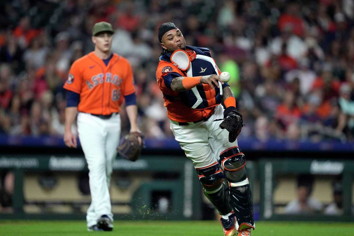 Houston Astros catcher Martin Maldonado throws to first after fielding a single by Oakland Athletics' Jace Peterson during the sixth inning of a baseball game Friday, May 19, 2023, in Houston.