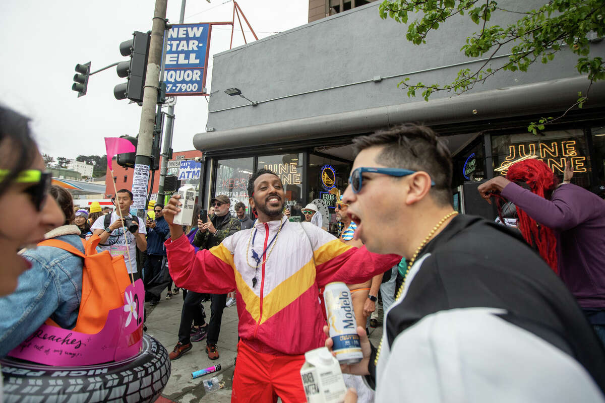 Revellers enjoy the Bay to Breakers footrace on Divisadero Street, San Francisco. May 21, 2023. 