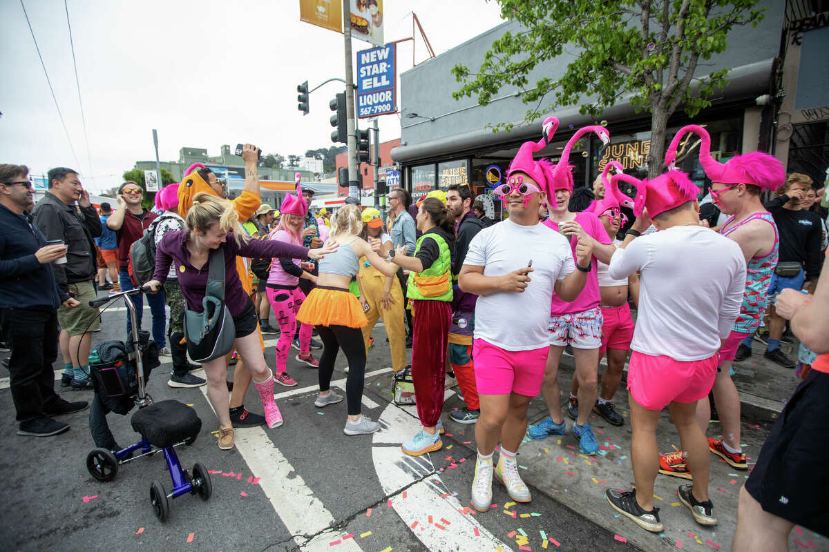 Revellers enjoy the Bay to Breakers footrace on Divisadero Street, San Francisco. May 21, 2023. 