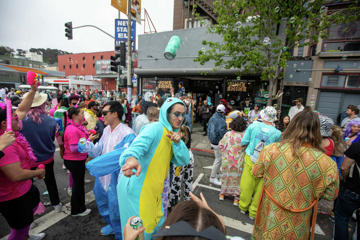 Revellers enjoy the Bay to Breakers footrace on Divisadero Street, San Francisco. May 21, 2023. 