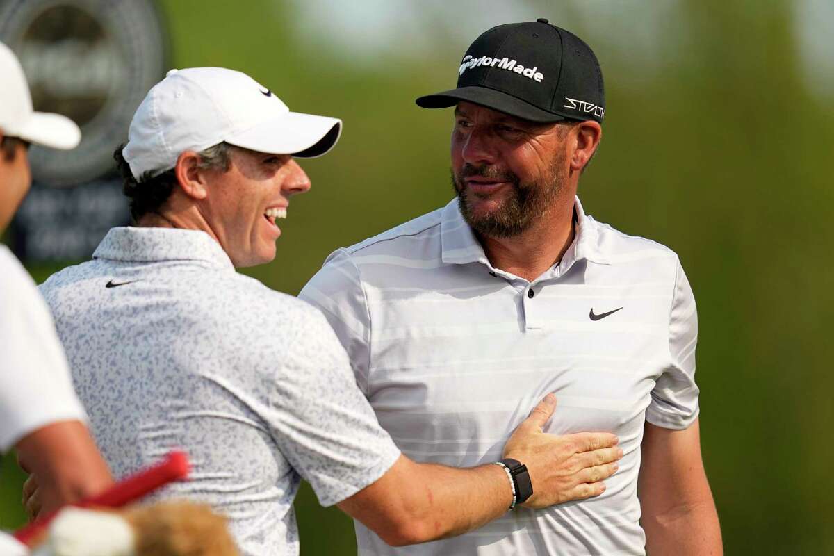 Rory McIlroy, of Northern Ireland, celebrates with Michael Block after Blocks's hole-in-one on the 15th hole during the final round of the PGA Championship golf tournament at Oak Hill Country Club on Sunday, May 21, 2023, in Pittsford, N.Y.