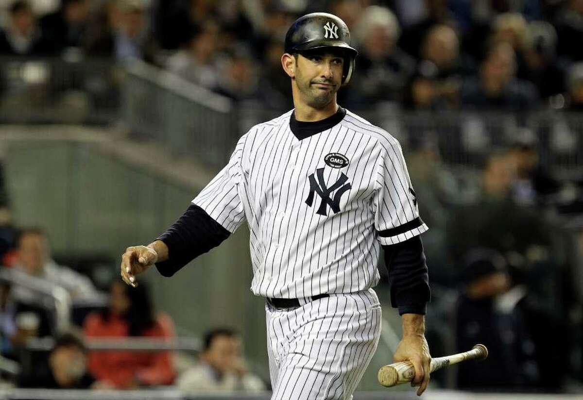NEW YORK - OCTOBER 18: Catcher Jorge Posada #20 of the New York Yankees reacts as he walks back to the dugout in the bottom of the third inning against the Texas Rangers in Game Three of the ALCS during the 2010 MLB Playoffs at Yankee Stadium on October 18, 2010 in New York, New York. (Photo by Al Bello/Getty Images) *** Local Caption *** Jorge Posada
