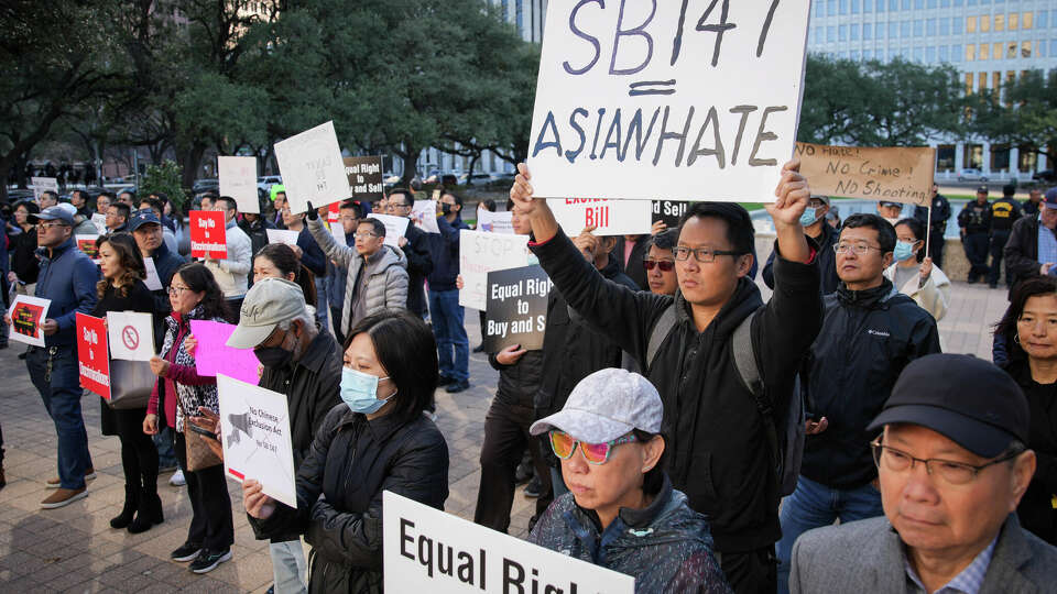 Protesters hold signs as politicians denounce SB 147 during a protest and press conference Monday, Jan. 23, 2023, at Houston City Hall in Houston.