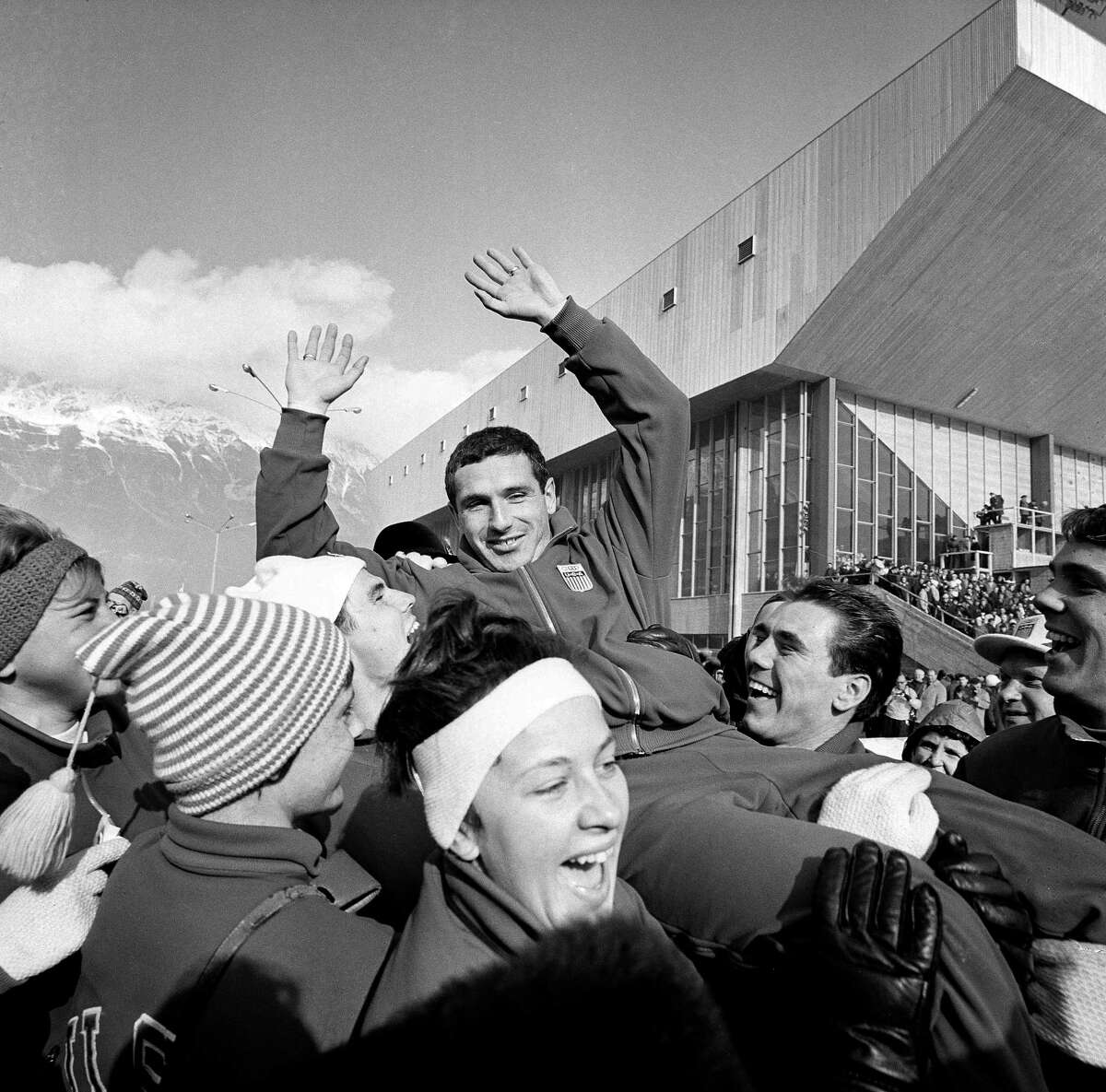 FILE - Terry McDermott, 23, who won the first gold medal for the U.S. in the ninth Winter Olympic games, is hoisted to the shoulders of teammates after his triumph at Innsbruck, Feb. 4, 1964. McDermott, who won the only gold medal for the United States at the 1964 Winter Olympics, died on Saturday, May 20, 2023, U.S. Speedskating said. He was 82.