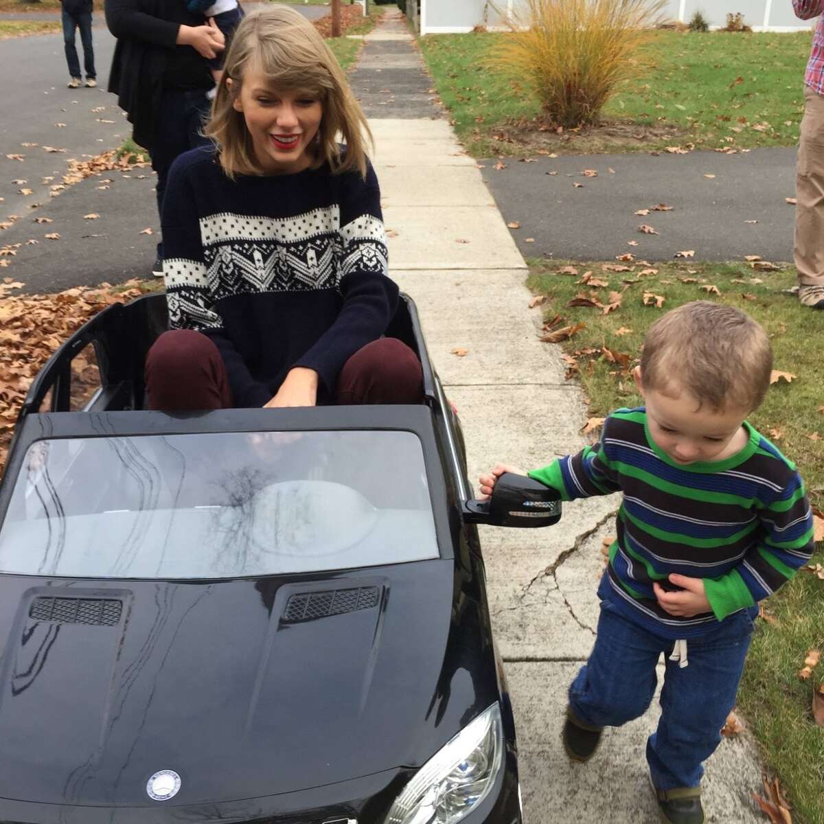 Taylor Swift (left) riding the electric toy vehicle she gifted Leyton Barnett (right) in North Haven back in 2014.