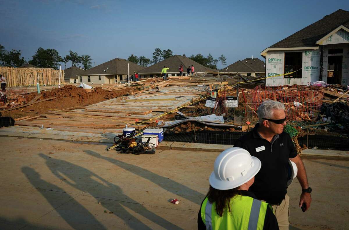 Officials from Lennar Homes work at a scene where a house under construction collapsed in high winds Tuesday, May 23, 2023, in Conroe. Officials said that two people were killed and seven were injured.
