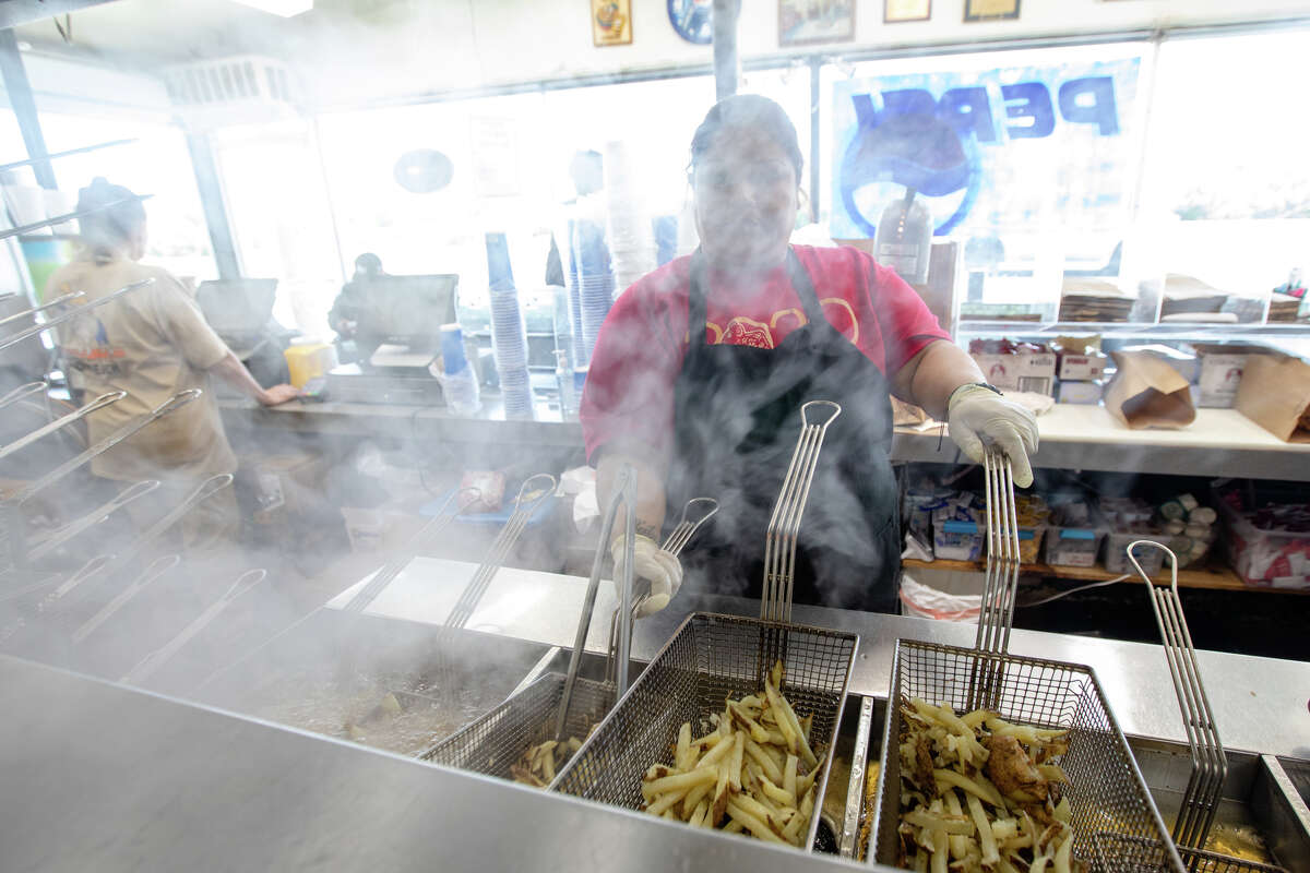 Alejandra Nayeli Perez prepares french fries at Bud's Giant Burgers in Vallejo, Calif. on May 24, 2023.