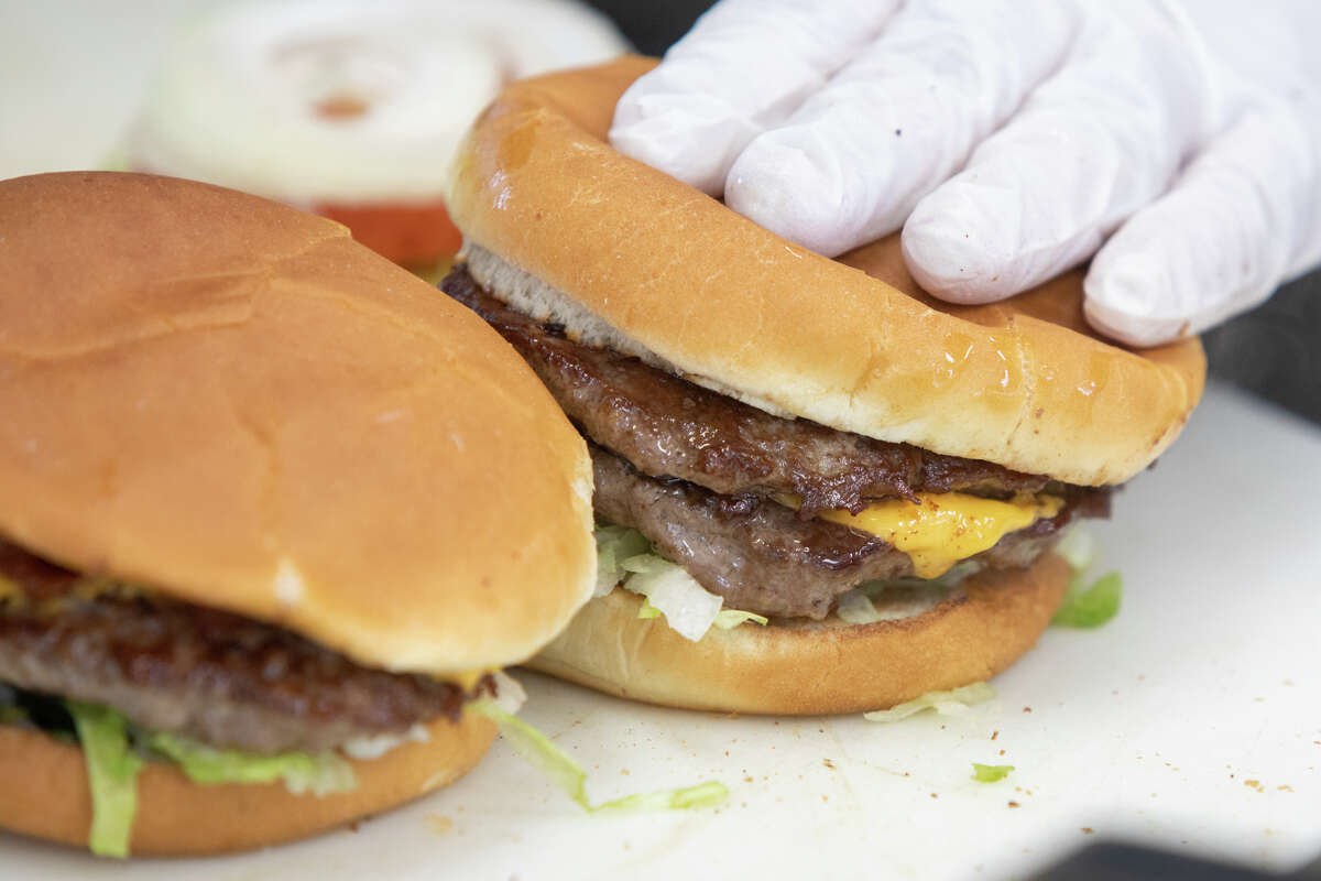 A cheeseburger and burger are assembled at Bud's Giant Burgers in Vallejo, Calif., on May 24, 2023.