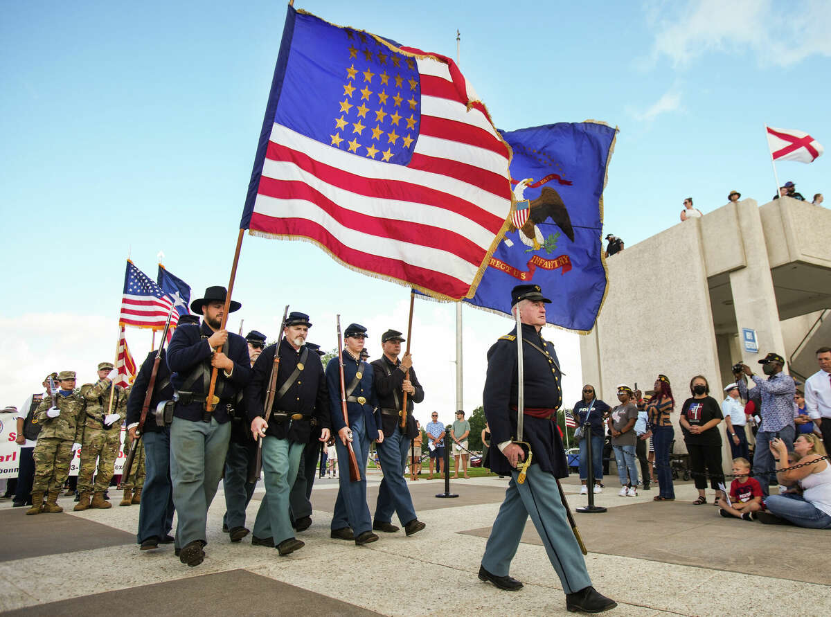 The Texas Rifle Co. A 13th U.S.  Infantry soldiers march in a parade of remembrance during a Memorial Day ceremony at the Houston National Cemetery, Monday, May 30, 2022, in Houston.  Hundreds of people attended the ceremony as it was held in public for the first time in two years due to the Covid-19 pandemic.