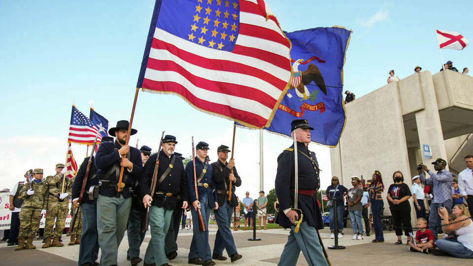 The Texas Rifle Co. A 13th U.AS. Infantry march in the parade of remembrance during the Memorial Day ceremony at the Houston National Cemetery Monday, May 30, 2022 in Houston. Hundreds of people gathered for the ceremony as it was held for the public for the first time in two years, due to the COVID-19 pandemic.