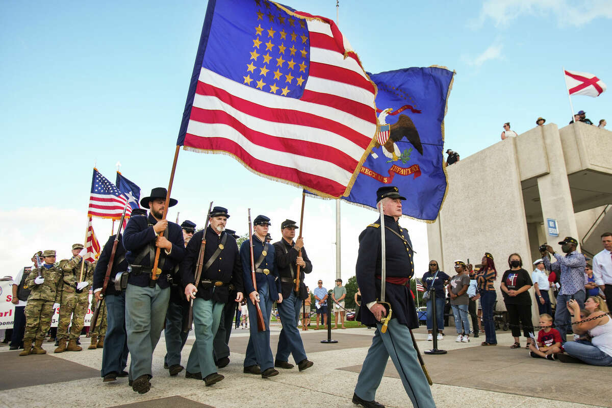 The Texas Rifle Co. A 13th U.AS. Infantry march in the parade of remembrance during the Memorial Day ceremony at the Houston National Cemetery Monday, May 30, 2022 in Houston. Hundreds of people gathered for the ceremony as it was held for the public for the first time in two years, due to the COVID-19 pandemic.