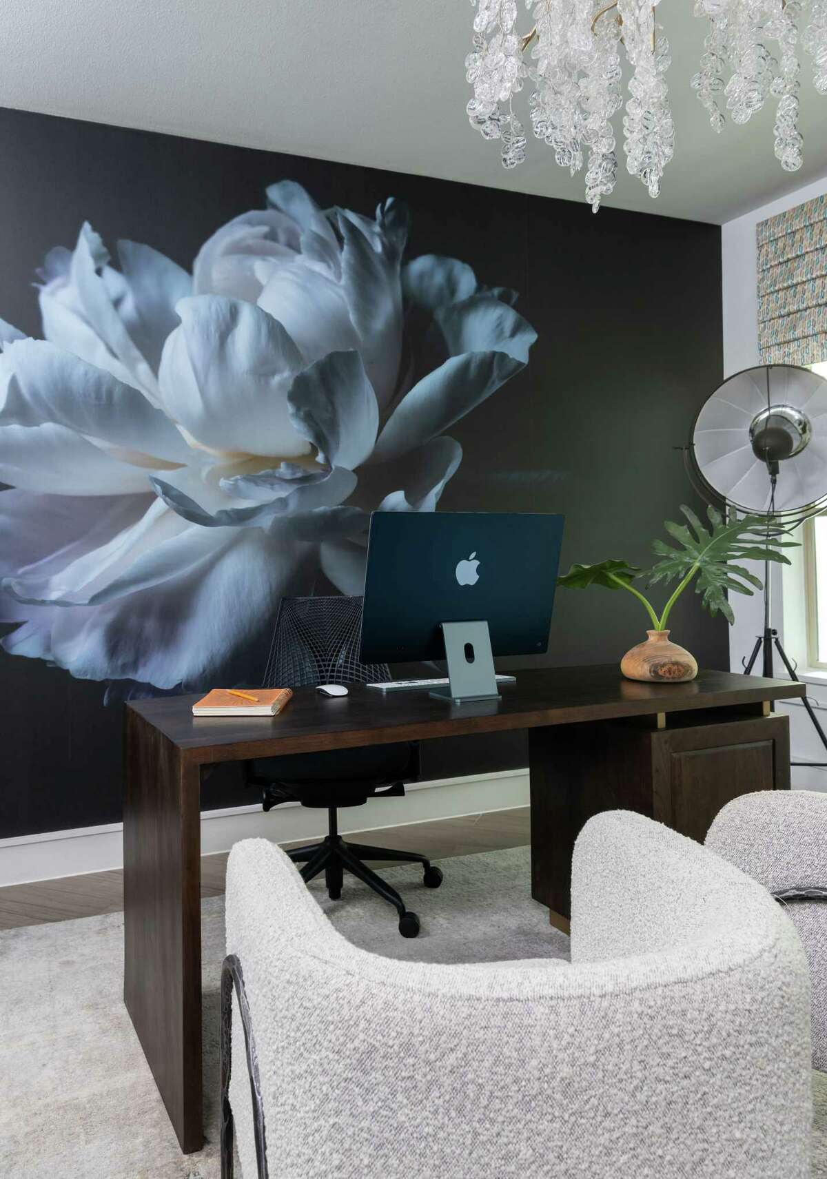 In her home office, Stewart installed a wall mural that used a photo of a large, white flower against a black background.