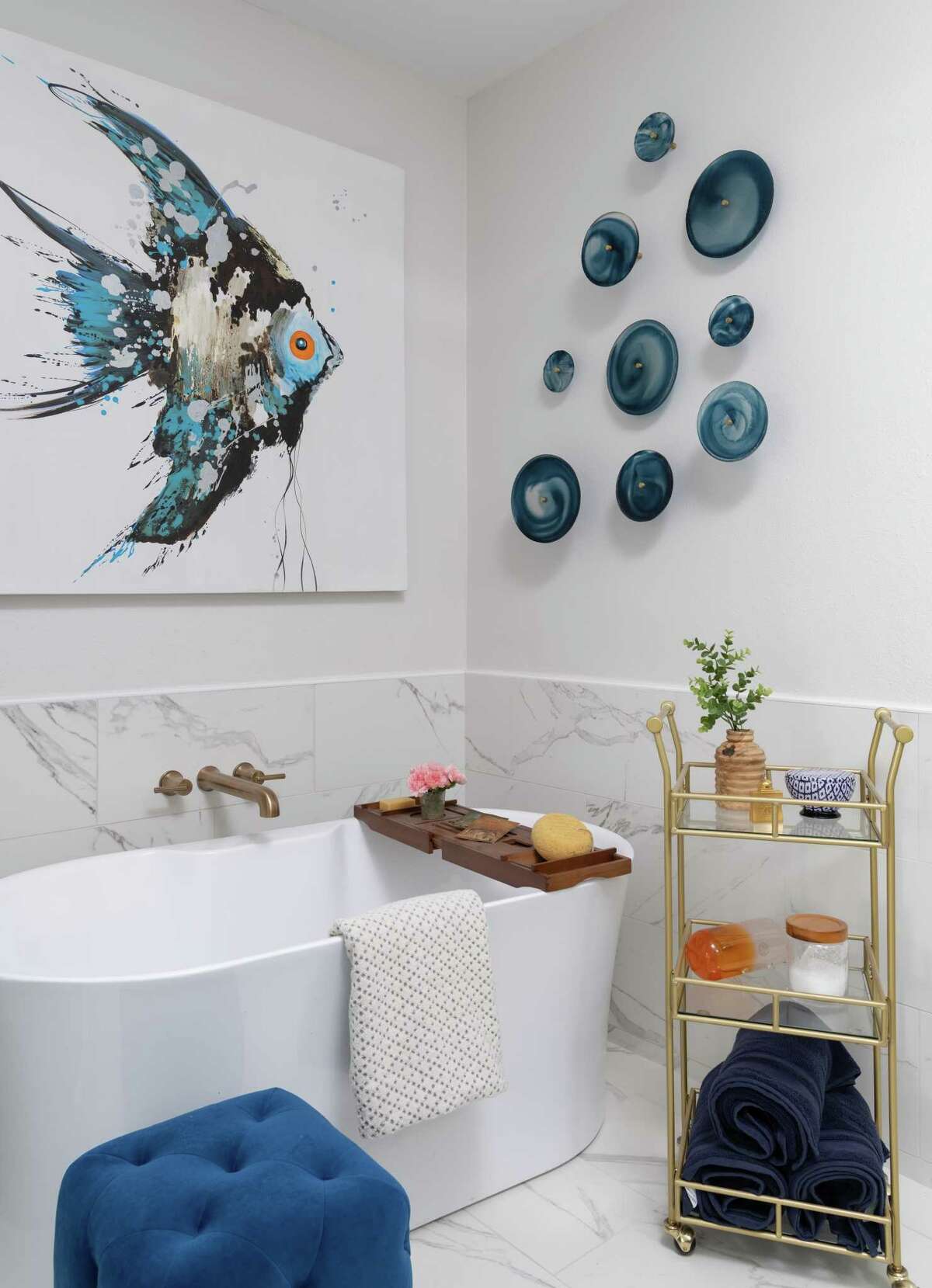 Stewart used the same porcelain tile on the floor, in the shower and partway up the wall behind a free-standing bathtub in the primary bathroom.