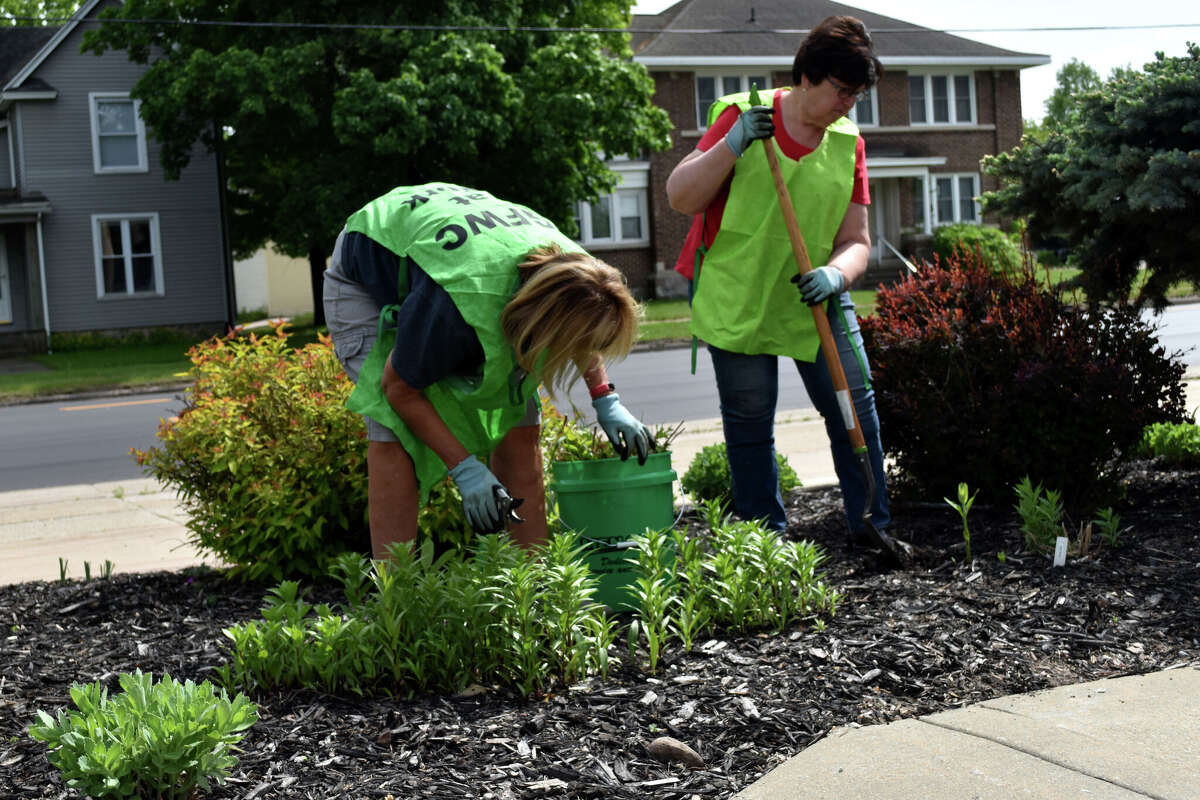 Big Rapids GFWC cleans up post office garden and Riverwalk entrance