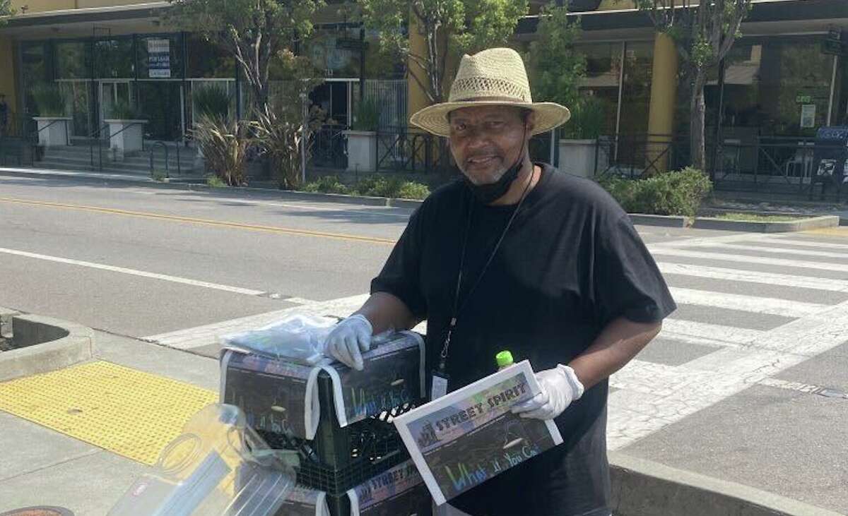 Street Spirit vendor Vernon Dailey sells copies of the newspaper outside of Good Earth in Fairfax. 