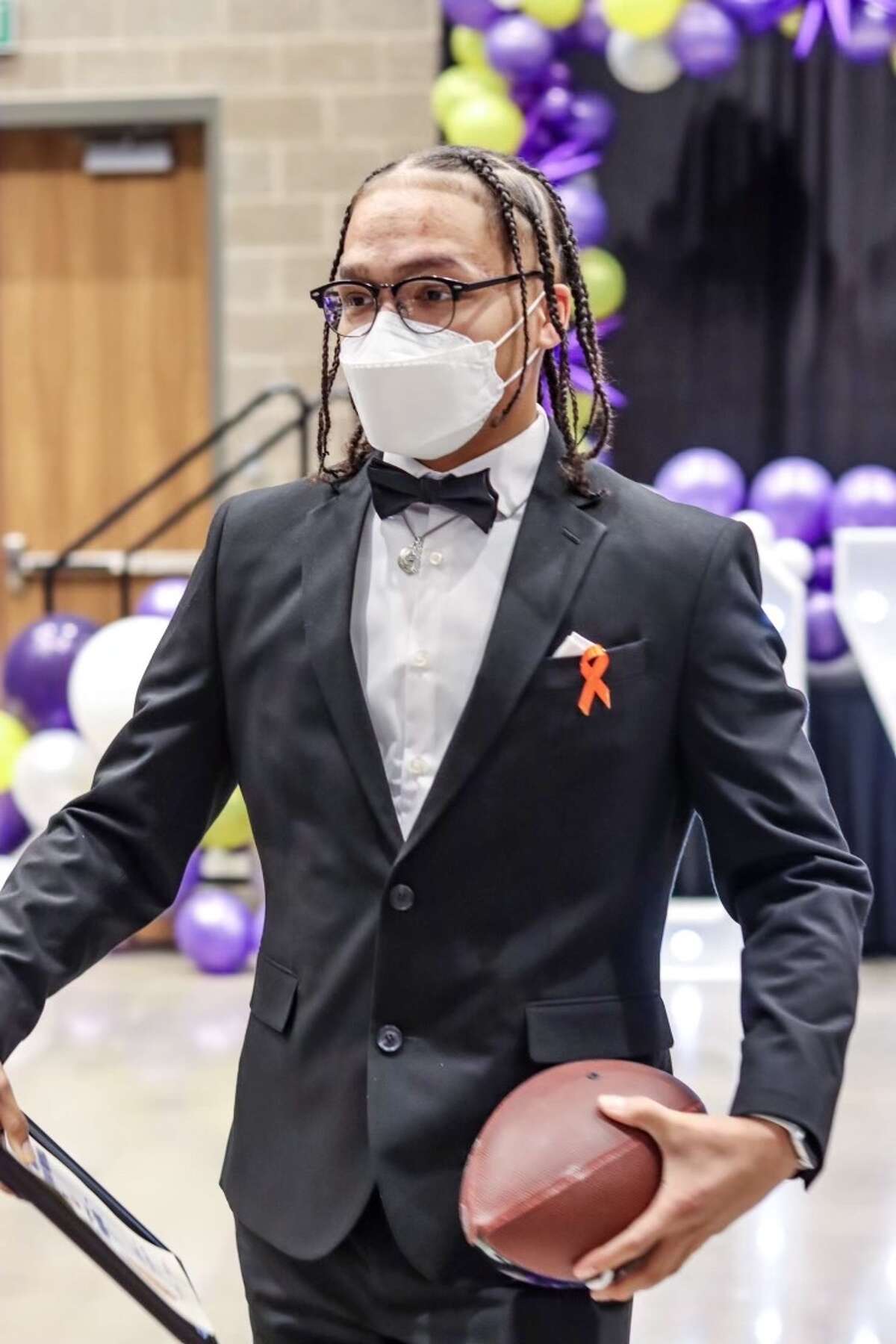 Le'Brian Perez sports a leukemia awareness ribbon at an MHS banquet.