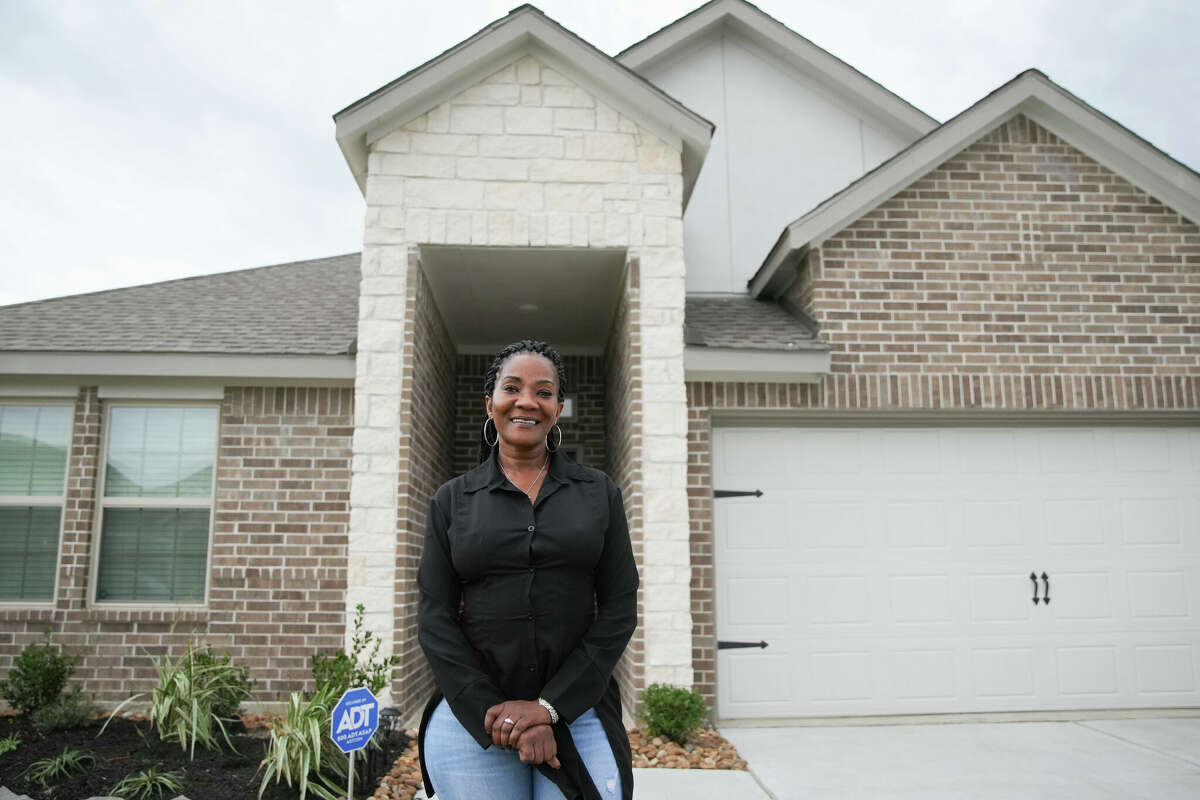 Frenda Dupree stands outside her new home on Friday, Dec. 16, 2022 in Baytown. Jackson, who moved to Houston for a job, saved money by using PadSplit, a co-living company that allows renters to lease out rooms for a more affordable price than renting out a whole apartment. After a few months, she was able to save enough money to be able to purchase her own home.