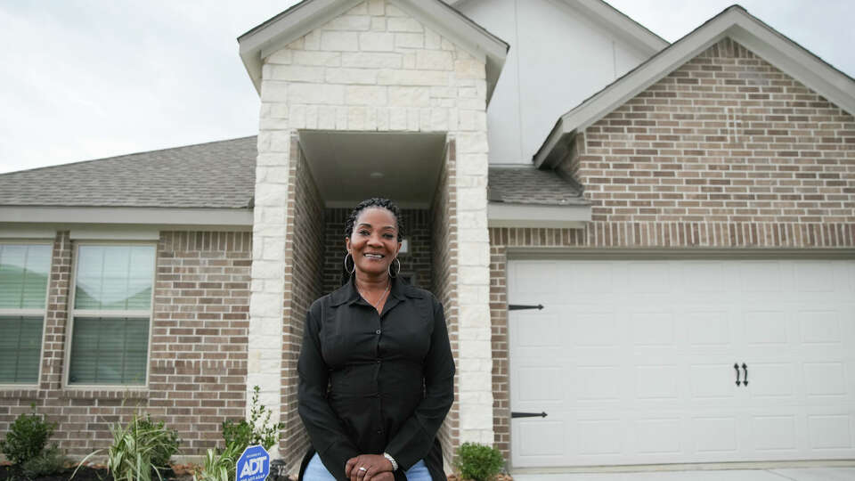 Frenda Dupree stands outside her new home on Friday, Dec. 16, 2022 in Baytown. Jackson, who moved to Houston for a job, saved money by using PadSplit, a co-living company that allows renters to lease out rooms for a more affordable price than renting out a whole apartment. After a few months, she was able to save enough money to be able to purchase her own home.