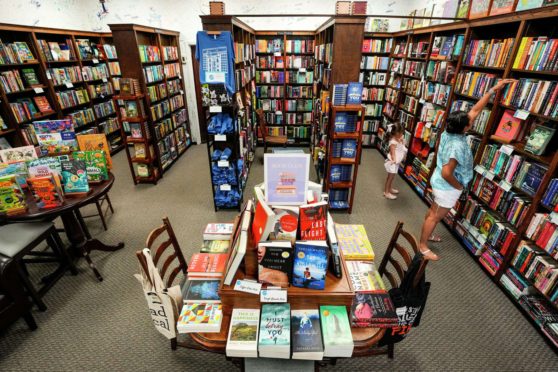 Natasha and Ava Bjoerndal shop at Blue Willow Bookshop on Friday, May 26, 2023 in Houston. Independent bookstores around the state warn that a bill sent this week to Gov. Greg Abbott designed to ban books with sexual content from schools could have unintended consequences that devastate their businesses and make it difficult and more expensive for schools to acquire new books.
