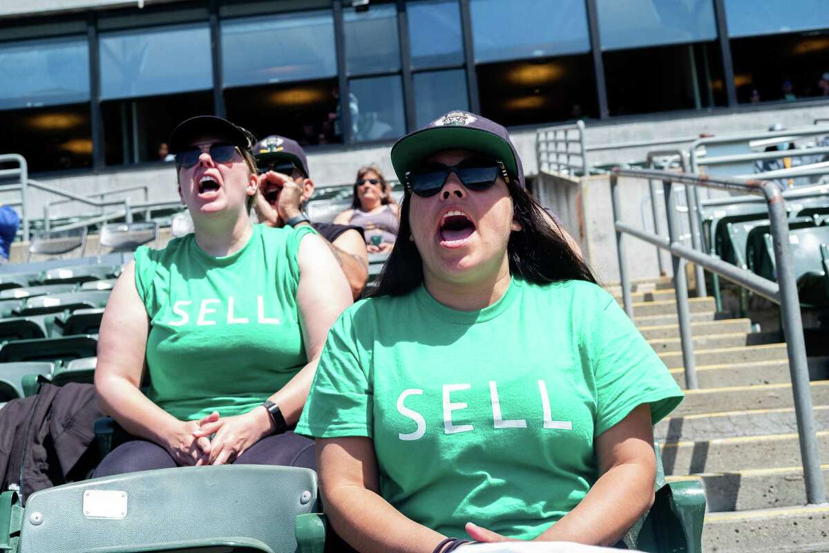 Michelle Lemon (left) and Cassandra Wilson (right) yell in protest against the Oakland A’s management during the game in Oakland on April 29. It was the second A’s home game since the announcement that the team plans to move to Las Vegas.