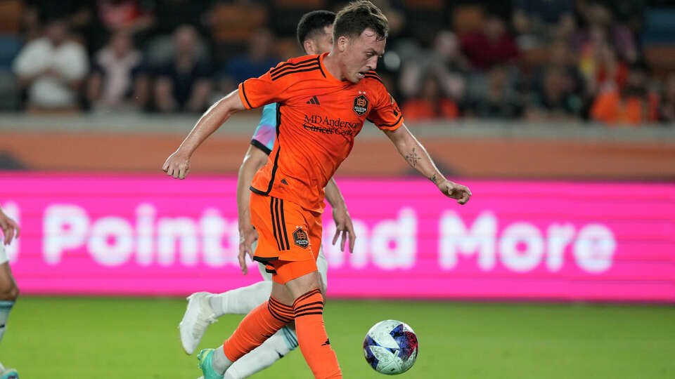 Houston Dynamo's Corey Baird shoots and scores a goal against Minnesota United during the second half of a U.S. Open Cup soccer match Tuesday, May 23, 2023, in Houston. The Dynamo won 4-0. (AP Photo/David J. Phillip)