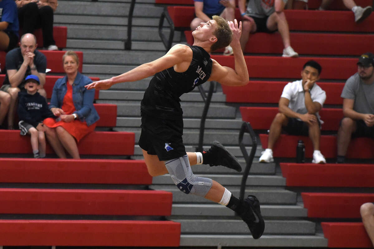 Darien's Trevor Herget (1) soars during a serve against Trumbull in the FCIAC boys volleyball final at Fairfield Warde on Friday, May 26, 2023.