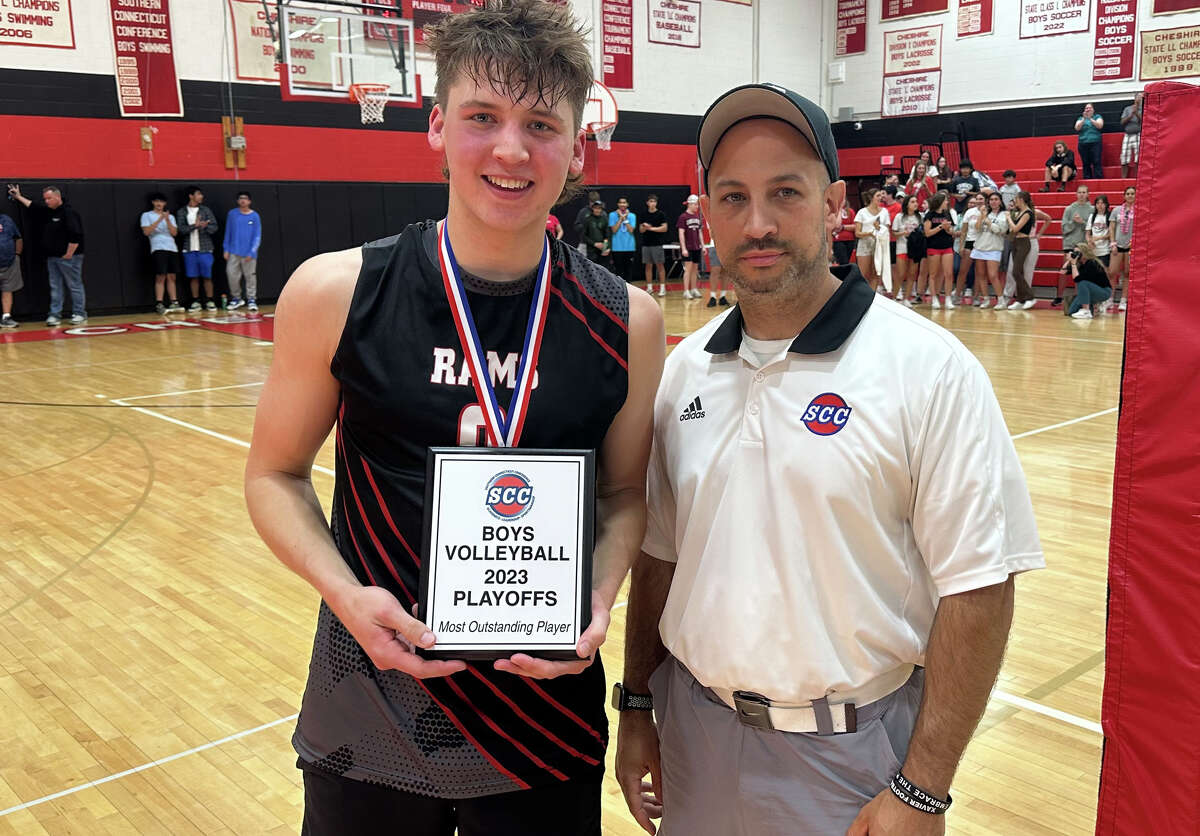 Will Allen of Cheshire is presented with the Most Outstanding Player Award for the SCC boys' volleyball tournament by Xavier Athletic Director Dan Deconti.