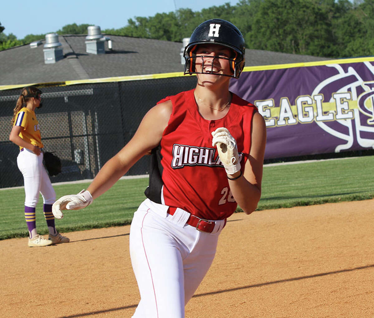 Highland's Maggie Grohmann looks to the Bulldogs' dugout while rounding third on her home run against CM on Friday in the title game of the CM Class 3A Regional at the Bethalto Sports Complex.