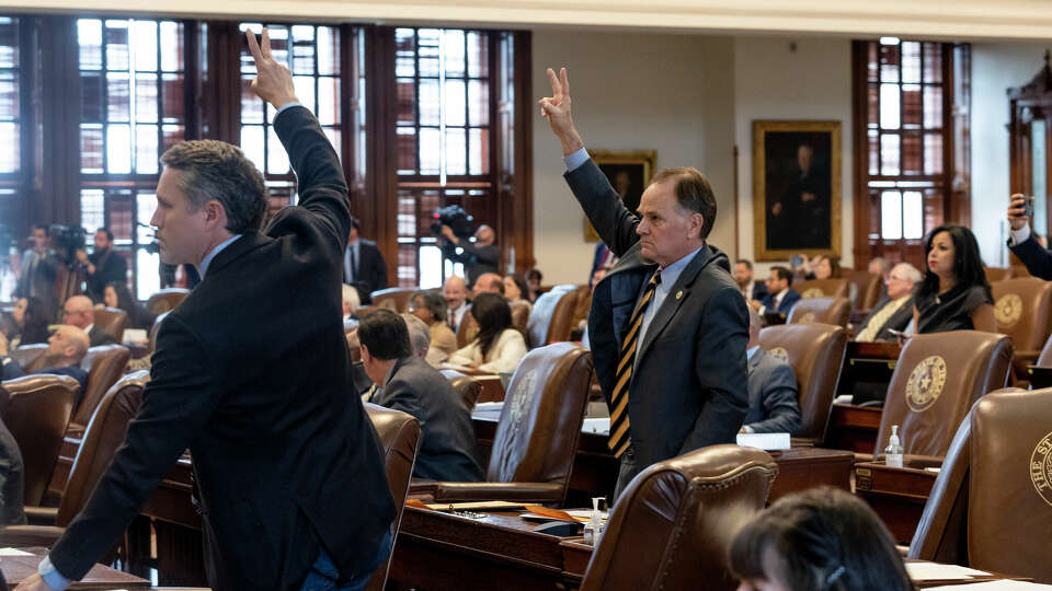 Rep. Steve Toth, R-The Woodlands, center, signals his vote against impeaching Texas Attorney General Ken Paxton in the Texas House of Representatives at the Texas Capitol in Austin, Texas, on May 27, 2023. Allegations against Paxton includes abuse of power to help a political donor and other offenses spanning nearly the past decade.