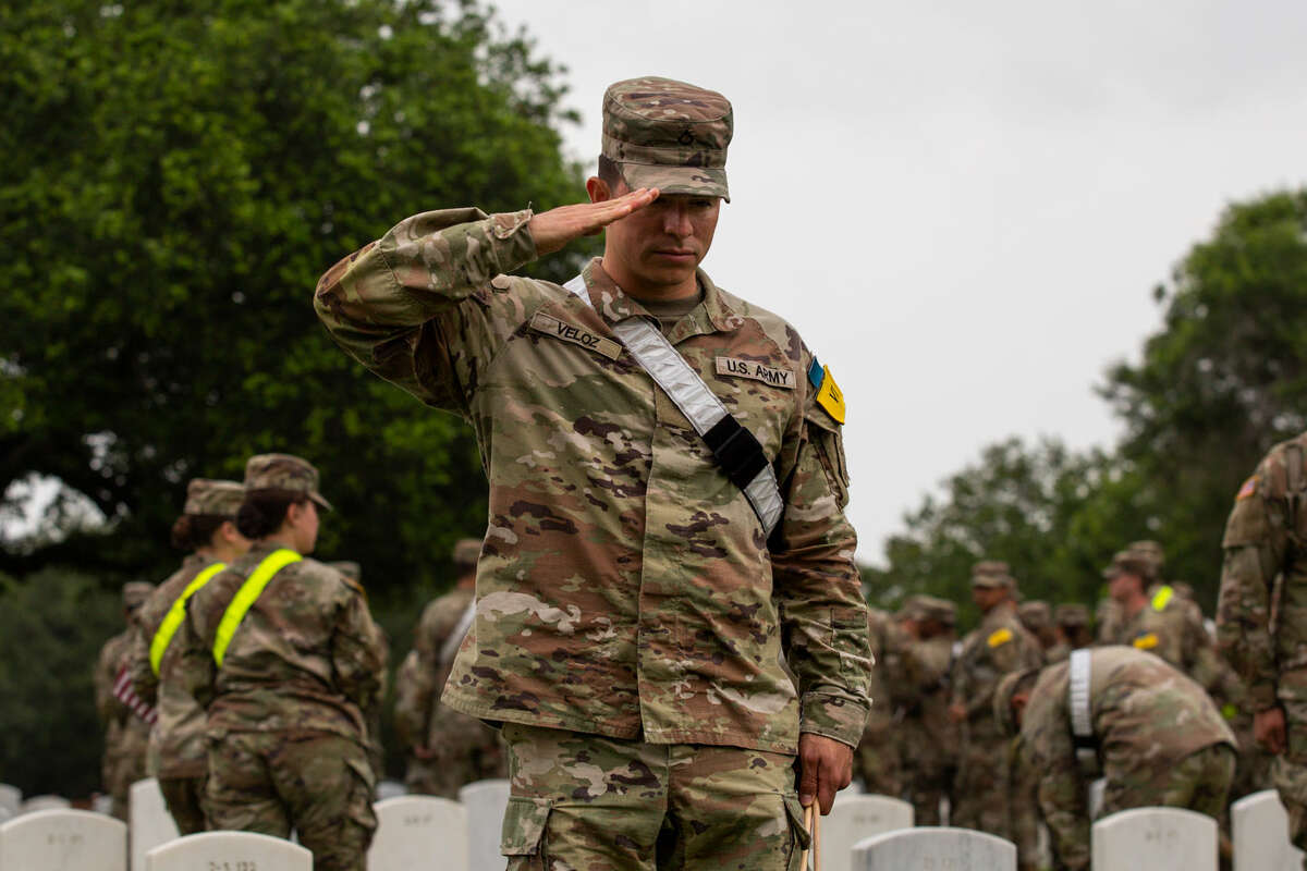 Memorial day. A female soldier in uniform salutes against the