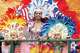 A group participating in the Carnaval Grand Parade wave to spectators along Mission Street in San Francisco in 2023.