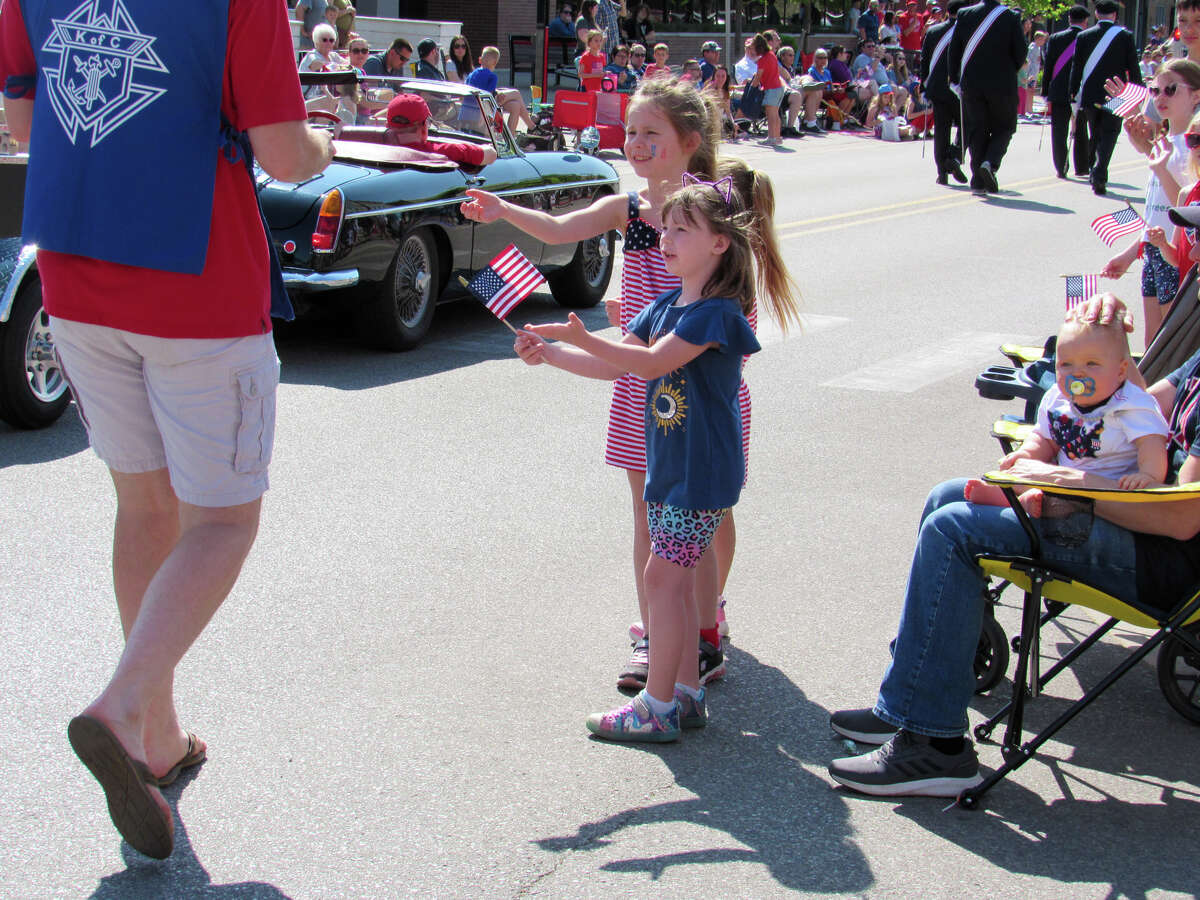 Two children receive candy from a Knights of Columbus member during the Memorial Day parade on May 29, 2023 in Downtown Midland. 