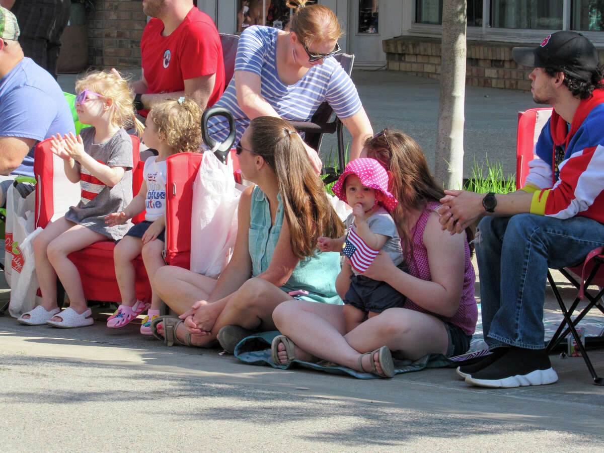 Families sit along Main Street to watch the Memorial Day parade on May 29, 2023 in Downtown Midland. 