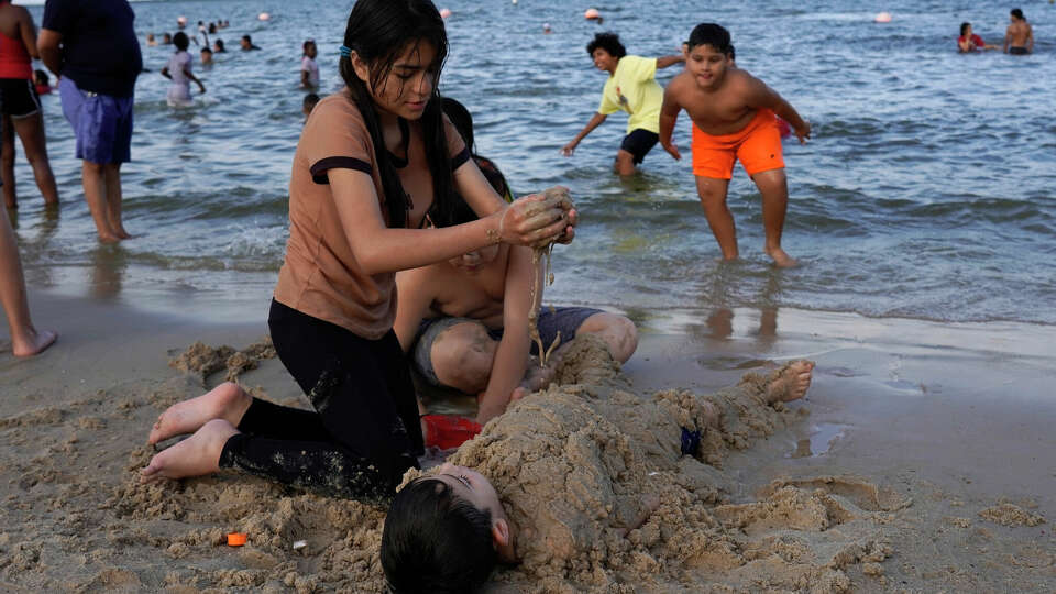 Children play on the beach at Sylvan Beach Park on Memorial Day, May 29, 2023, in La Porte, Tx.