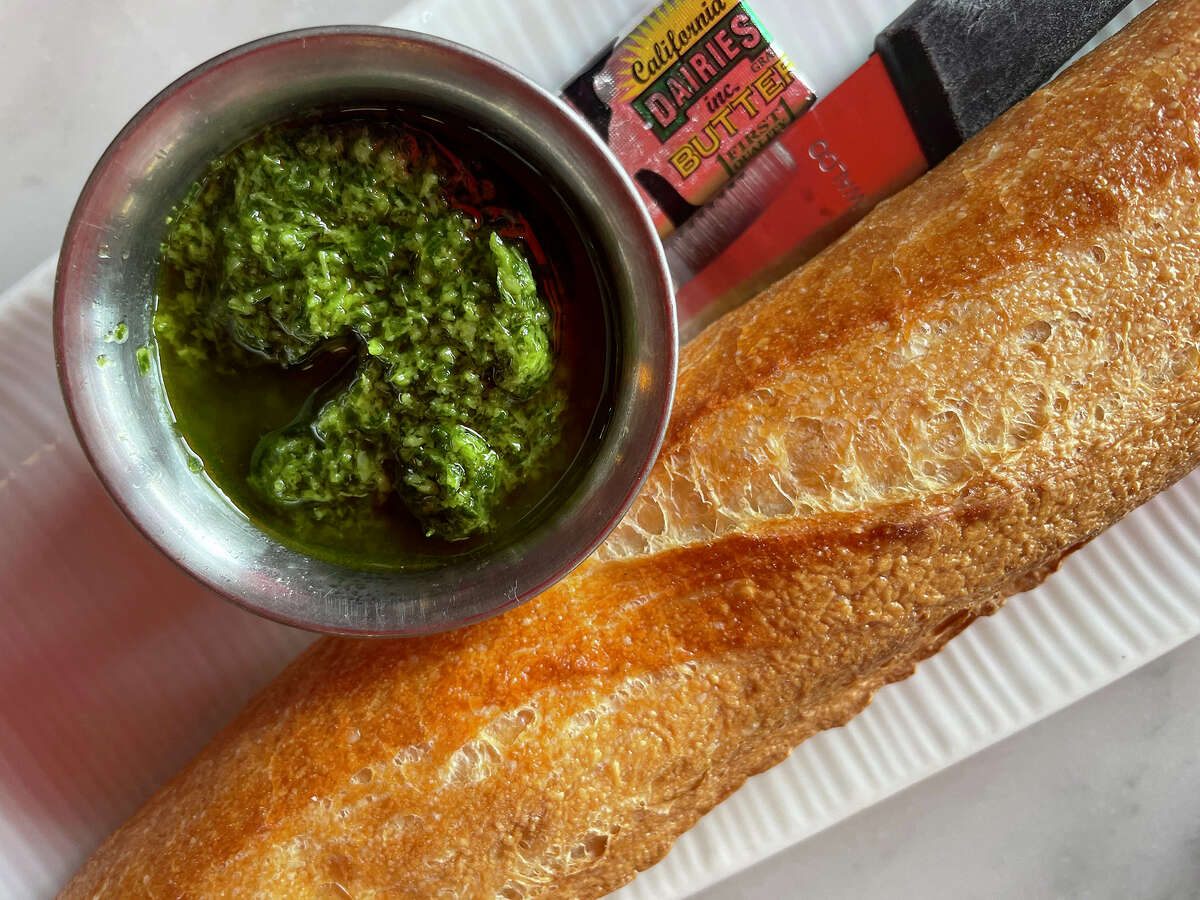 Fresh baked baguette with garlic relish at the Stinking Rose in San Francisco, on Thursday, May 25, 2023. 