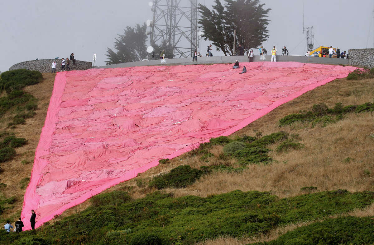Volunteers finish installing the giant pink triangle on Twin Peaks to kick off Pride Month festivities in San Francisco, Calif.