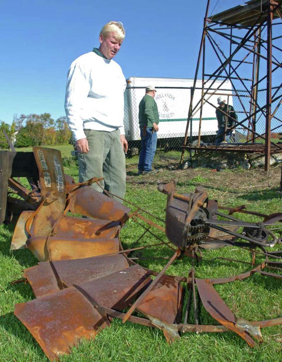 Eugene Reelick, of Hollandia Nursery in Bethel, disassembles a windmill at Happy Landings open space in Brookfield, Oct. 19, 2010. The windmills are considered a local landmark, but they were falling into disrepair. They will soon be repainted and placed back.