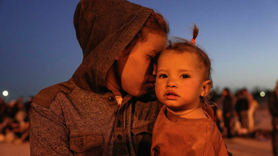 Dailimar Guadalupe Valera, 19 holds her one year old daughter Antonella while she waits with her family and hundreds of migrants cross the Rio Grande from Ciudad Juarez to El Paso hoping to be able to seek asylum and enter the United States on Wednesday, May 10, 2023 in Ciudad Juarez.