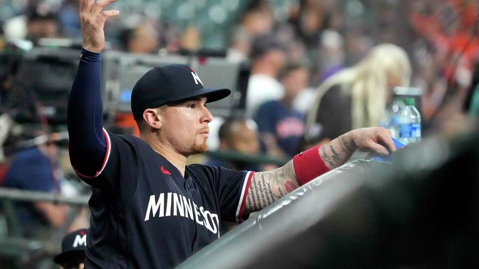 Minnesota Twins catcher Christian Vazquez (8) waves over to the Astros dugout before the start of the first inning of an MLB baseball game at Minute Maid Park on Wednesday, May 31, 2023, in Houston.