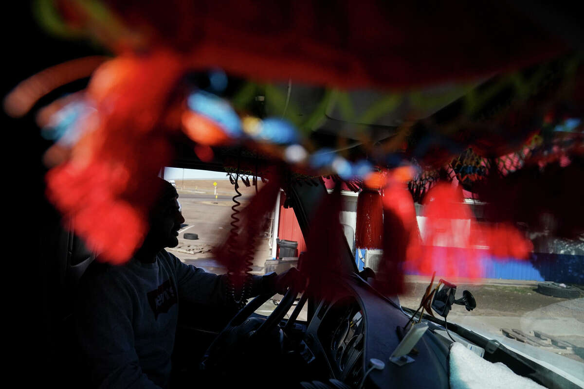 Palwinder Singh sits in his truck at the Vega Truck Stop, owned by the Sandhu family, in Vega, Texas, on Feb. 16. With Punjabi truckers making up 20% of the U.S. trucking industry, restaurants such as Taste of India in Buttonwillow, Calif., have found loyal customers in those traveling through.