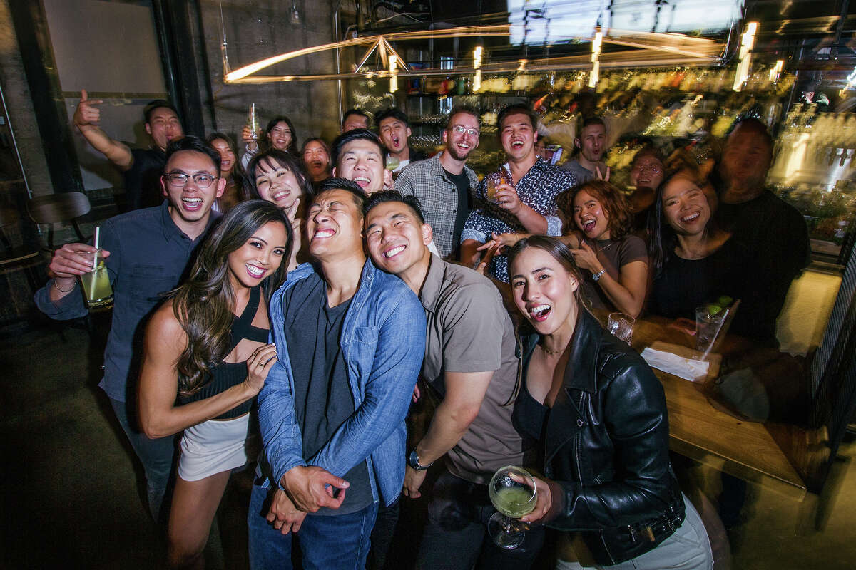 Guests go big and squeeze in for a group shot with birthday guy Daniel Yang, second from bottom right, at Dragon Horse in San Francisco Calif. May 20, 2023