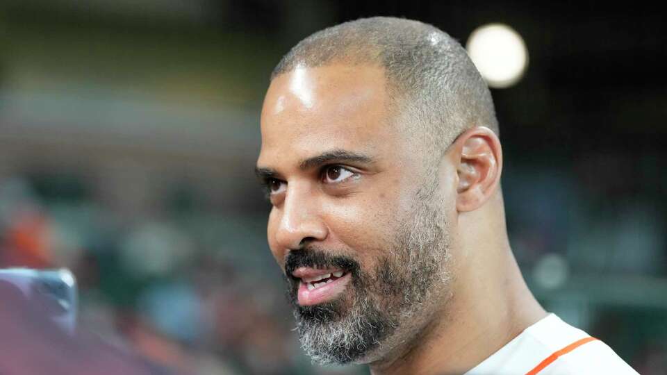 Houston Rockets head coach Ime Udoka reads to throw out the first pitch before the start of the first inning of an MLB baseball game at Minute Maid Park on Thursday, June 1, 2023, in Houston.